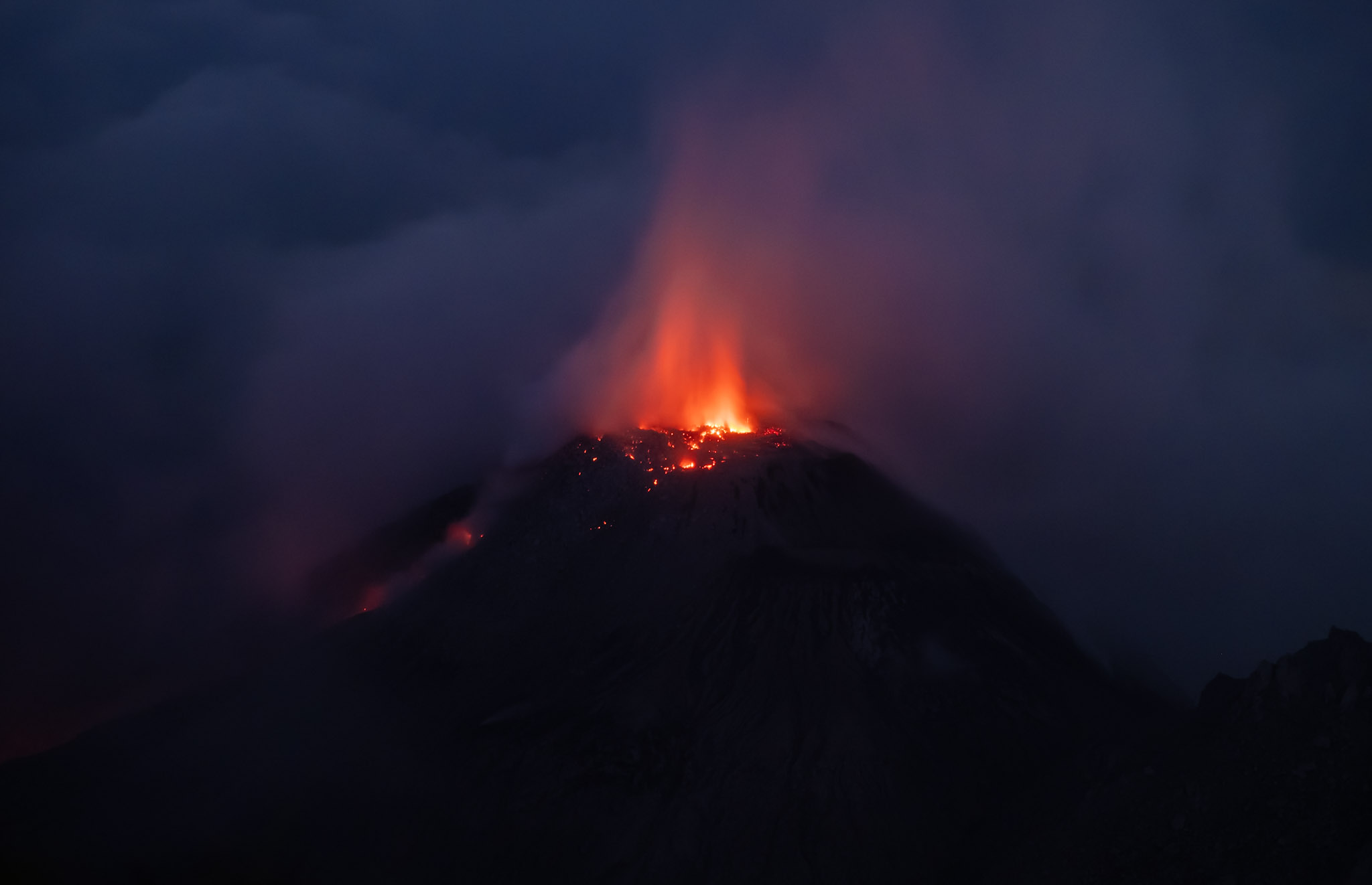 santiaguito erupting through the clouds