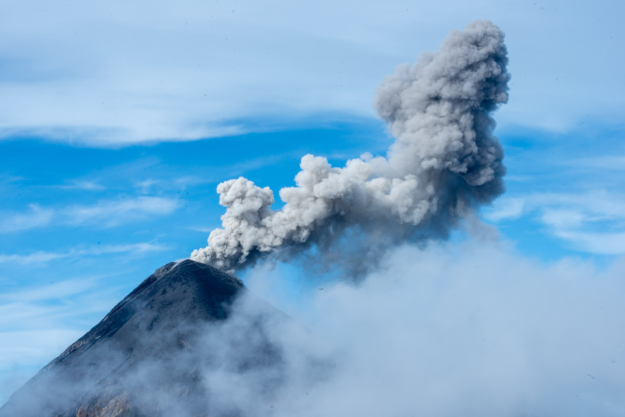 Volcán de Fuego erupting in the clouds.